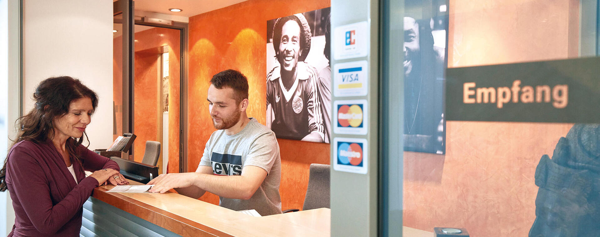 Guest checks in at the reception of the international student hotel